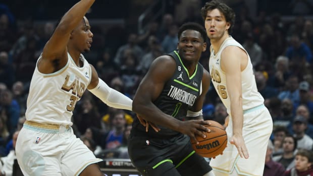 Nov 13, 2022; Cleveland, Ohio, USA; Minnesota Timberwolves guard Anthony Edwards (1) drives to the basket against Cleveland Cavaliers forward Isaac Okoro (35) and forward Cedi Osman (16) during the first half at Rocket Mortgage FieldHouse.